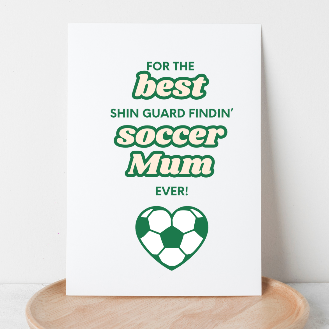 white greeting card with the words for the best shin guard findin' soccer mum ever! in green and cream with a love heart shaped soccer ball.