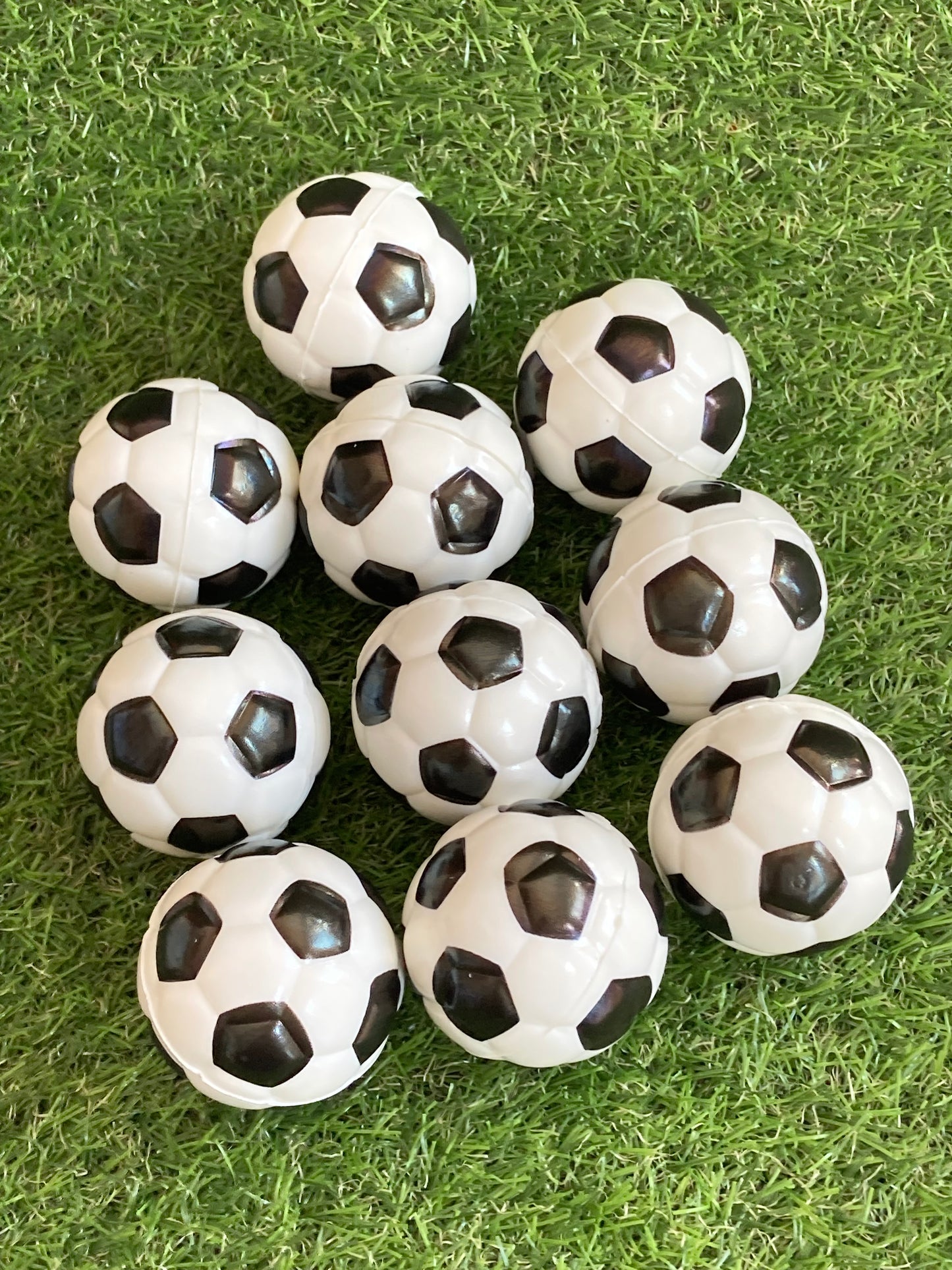 10 Soccer small soccer balls laying on grass
