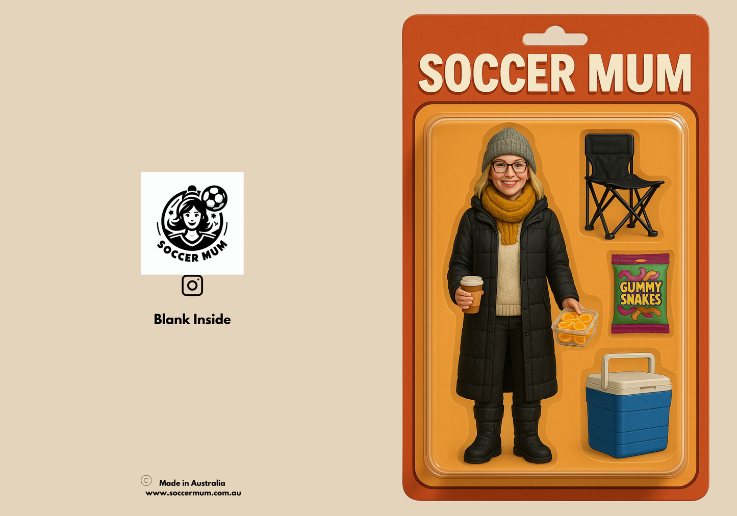 Flat lay greeting card. Tan coloured greeting card with an image of a boxed action figure called soccer mum. In the bubble packaging is a mum in a black coat, with scarf and hat holding coffee and sliced oranges. Her accessories are an esky, packet of gummy snakes and folding chair, with an orange back card.
