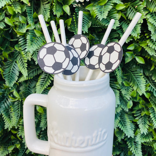 White Mason Jar with white straws topped with soccer ball paper straw toppers.