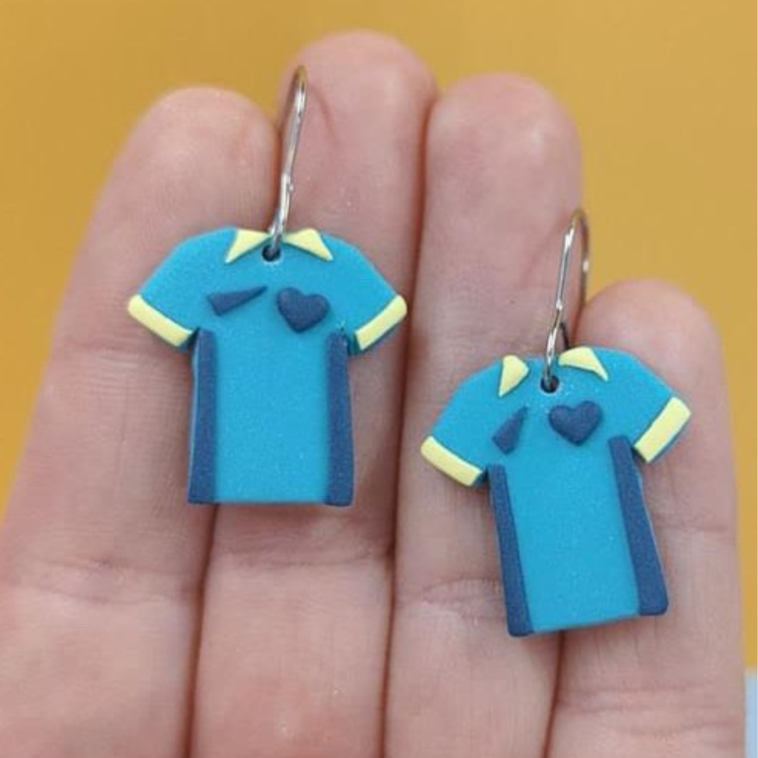  Matilda teal and yellow soccer kit shirts on a hand for size comparison.